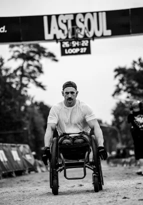 A wheelchair athlete pushes towards the Last Soul start line on loop 27